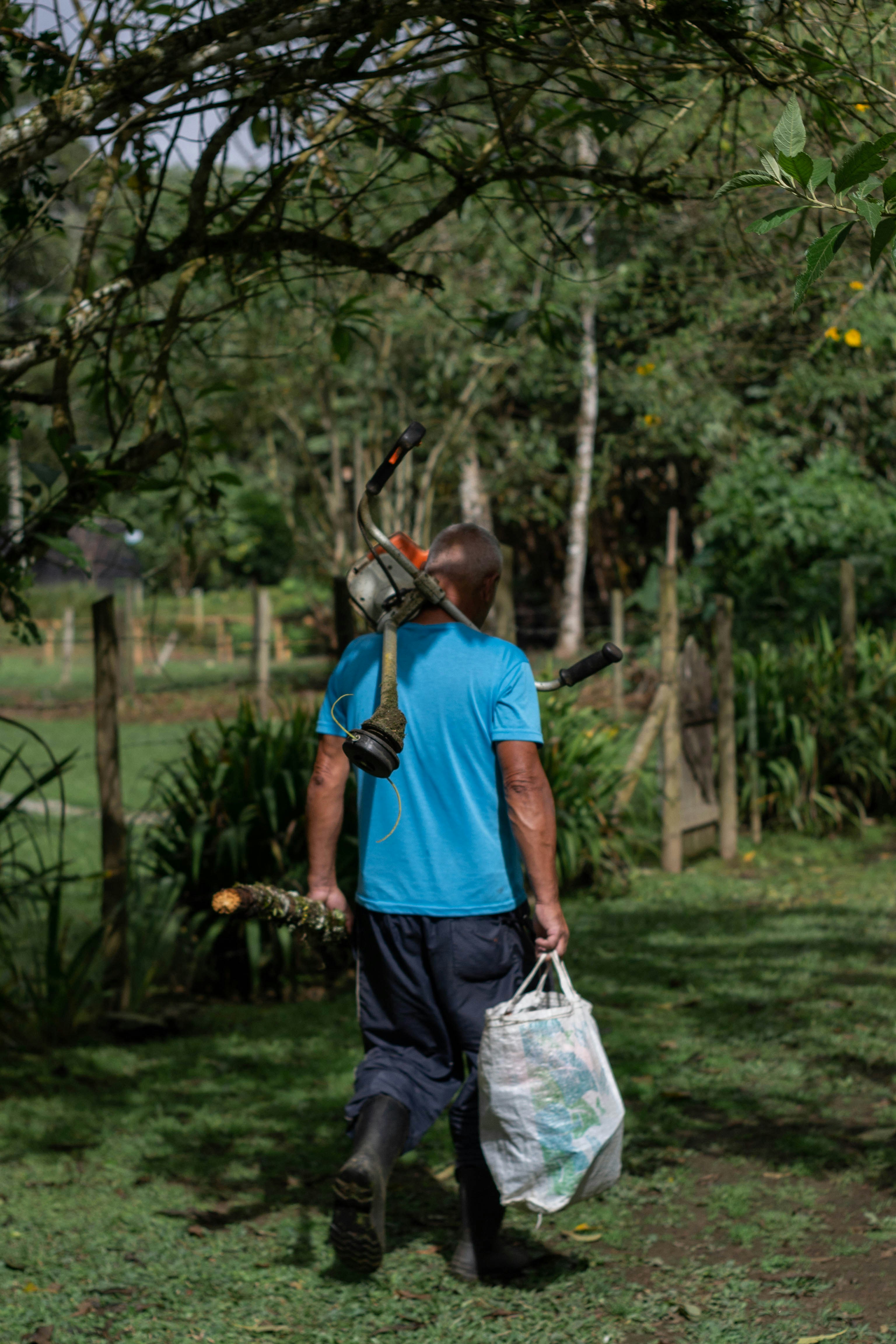 Groundskeeper carrying a backpack blower