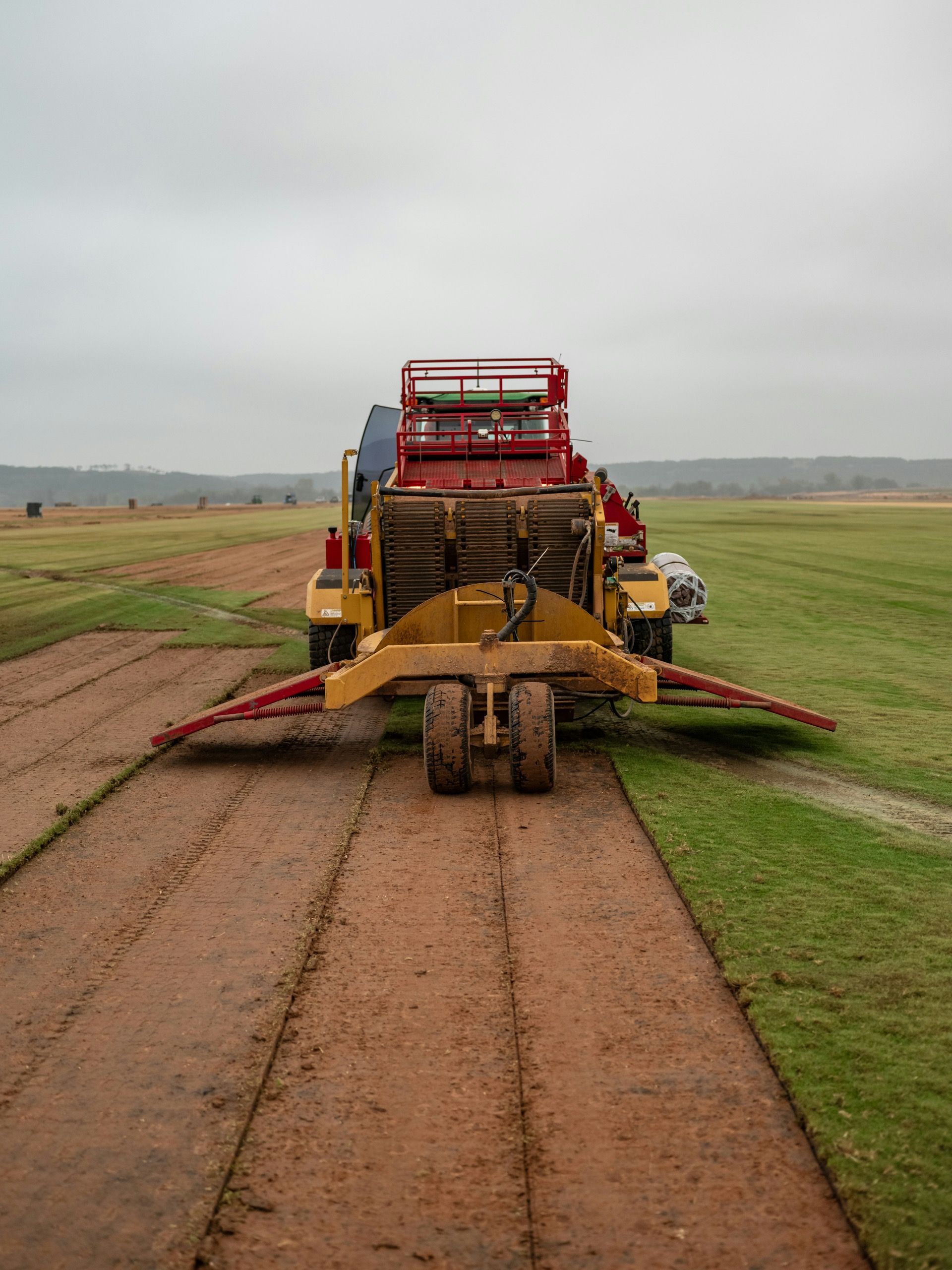 Commercial sod harvesting machine on turf field